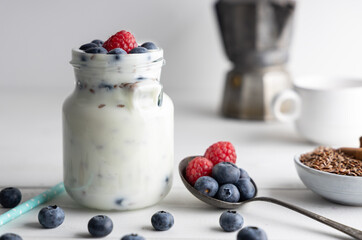 Portion of flax seeds in a small bowl. Healthy super foods flax seeds in a bowl mixed with yoghurt ready to eat. These seed are very healthy and can be eaten with a variety of different dishes.