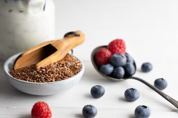 Portion of flax seeds in a small bowl. Healthy super foods flax seeds in a bowl mixed with yoghurt...