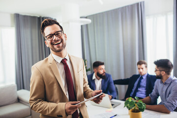 Leader ceo or professional business coach looking at camera posing in office with diverse happy team at background.