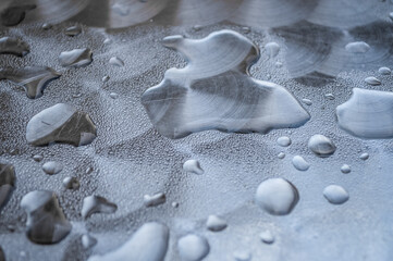 Close up view of water rain drops on a metal surface
