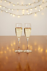 Two glasses of wine with bokeh background close up. Top view. New Year, Christmas mood. Greeting card. Party and holiday celebration concept.