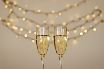 Two glasses of wine with bokeh background close up. Top view. New Year, Christmas mood. Greeting card. Party and holiday celebration concept.