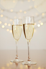 Two glasses of wine with bokeh background close up. Top view. New Year, Christmas mood. Greeting card. Party and holiday celebration concept.