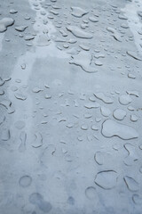 Close up view of water rain drops on a metal surface