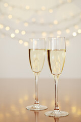 Two glasses of wine with bokeh background close up. Top view. New Year, Christmas mood. Greeting card. Party and holiday celebration concept.