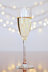 Glass of wine with bokeh background close up. Flat lay. New Year, Christmas mood. Greeting card. Party and holiday celebration concept.