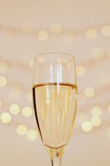 Glass of wine with bokeh background close up. Flat lay. New Year, Christmas mood. Greeting card. Party and holiday celebration concept.