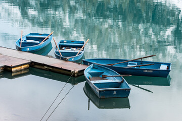blue rowing boats on mountain lake