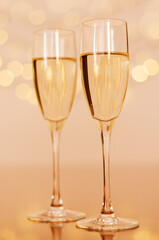 Two glasses of wine with bokeh background close up. Top view. New Year, Christmas mood. Greeting card. Party and holiday celebration concept.