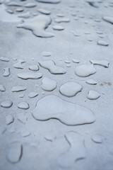 Close up view of water rain drops on a metal surface