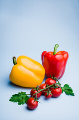 Vegetables bell pepper and tomatoes on blue background