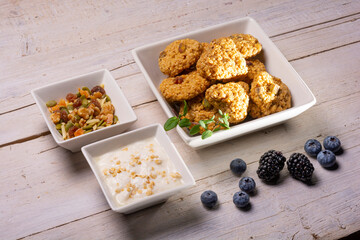 Breakfast with oatmeal cookies, seeds, blueberries, blackberries and yogurt
