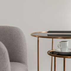 Armchair with two coffee tables, close-up