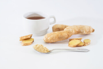 Fresh ginger root, cup of tea and ginger powder in spoon isolated on white background