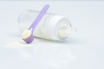 Baby milk bottle, Baby food. Powder in spoon and baby bottle