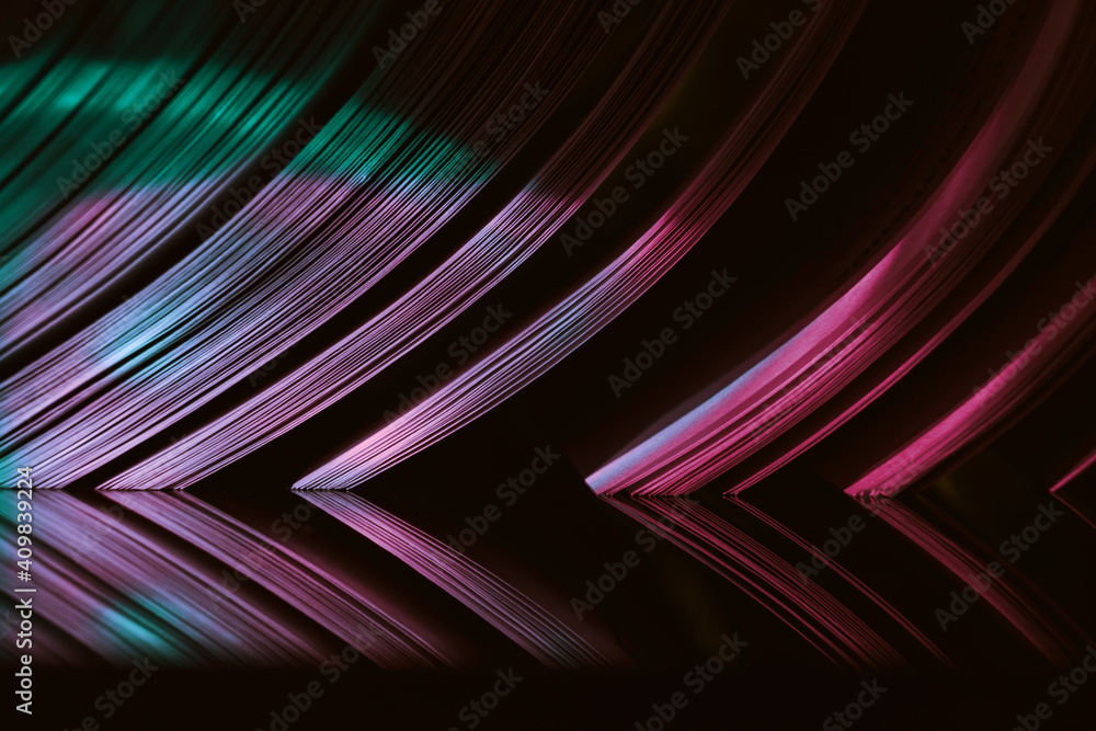 Fototapete Close up Beautiful book pages in the multi color light on a night. Background pattern for design. Macro photography view.