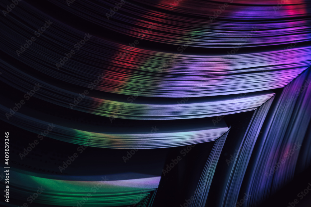 Aufkleber Close up Beautiful book pages in the multi color light on a night. Background pattern for design. Macro photography view.