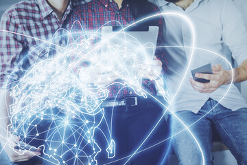 Double exposure of business theme drawing and man and woman working together holding and using a mobile device.