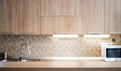 blurred kitchen interior and wooden desk space home background