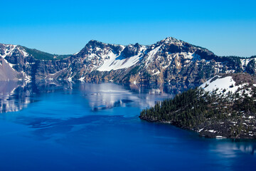 Beautiful Mountain range around blue water in the Crater Lake National Park, Oregon