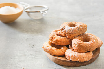 Homemade donuts sugar glazed on a stone background