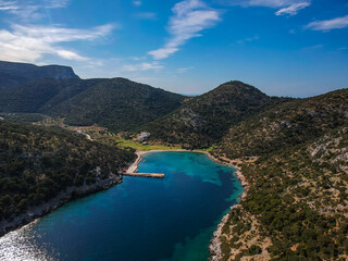 Aerial panoramic view of the picturesque old harbor Gerakas in northern Alonnisos, Greece. Beautiful scenery with rocky formation and natural fjord-like bay in Sporades Aegean sea, Greece