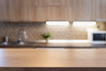 blurred kitchen interior and wooden desk space home background