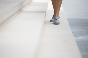 Woman wearing grey shoes outside © Stanislav