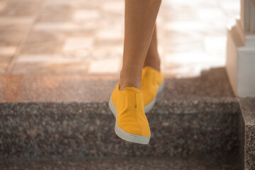 Woman wearing yellow shoes outside © Stanislav