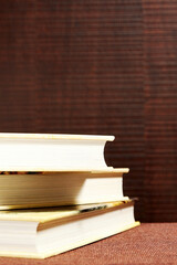 Messy stack of books on the brown bookshelf in the library. Bookstore backgrounds