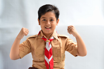 A portrait of an asian boy wearing scout clothing
