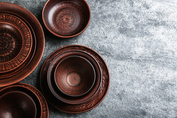 Set of clay utensils on grey table, flat lay. Space for text