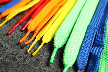 Colorful shoelaces on grey background, closeup. Stylish accessory - obrazy, fototapety, plakaty