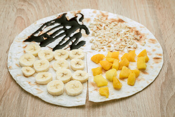 quick taco snack with bananas, mango, peanuts and chocolate spread. Junior cooking
