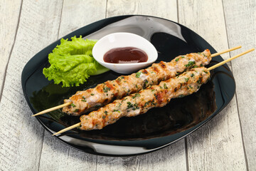 Minced pork skewer kebab with sauce