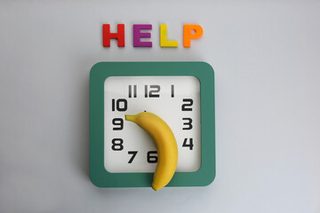 Clock with banana and word HELP on grey background, flat lay. Potency problem concept