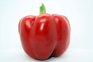 The fruit of a red sweet pepper on a white background.