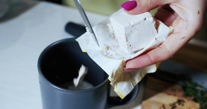 Preparing homemade food in the kitchen by a woman. Dough yeast. Slow motion.