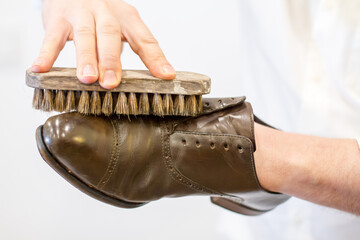 old traditional brush Polishing shoes, this shoemaker is buffing leather brogue shoes