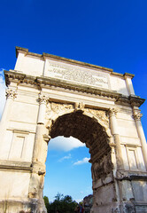 Fototapeta na wymiar Arch of Titus in Rome, Italy. It was built in 1st Century a.c. and has provided the general model for many triumphal arches built in more recent times, as for example famous Arc de Triomphe in Paris.