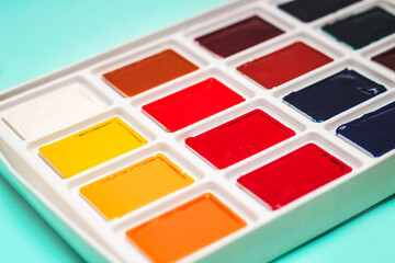 Professional watercolor paints in cuvettes. Multi-colored paints for artists.