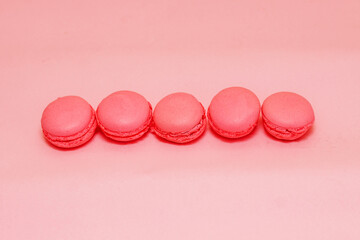 French pink macaroon cookies on silk tablecloth