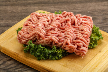 Raw pork minced meat over board