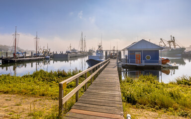 Various ships moored on a wooden quay