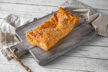 Puff pastry bun stuffed with apples, berries, or cottage cheese and potatoes, mini pie. Bakery products. Sweet pastry.