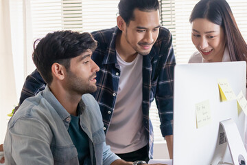 Group, Team of young asian colleagues or contractors, engineer brainstorming, discussing and talking to plan on screen computer on the table, desk at workplace, office.Working people concept.