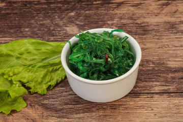 Green Chuka Seaweed Salad Isolated on White Background Top View. Wakame Sea Kelp Salat