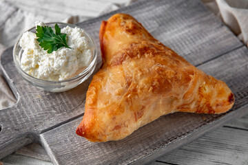 Placinda pie stuffed with cottage cheese and herbs. Rich pastries.