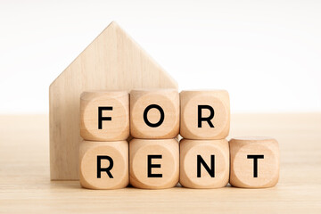 For Rent concept. Real estate market. Wooden blocks with text and house icon. Copy space