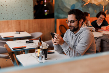 Man in restaurant looking at phone